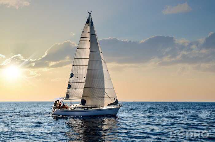 Poster close-up sailboat sailing under a beautiful sunset