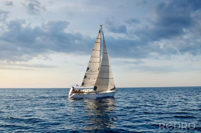 Poster close-up sailboat sailing under a beautiful sunset