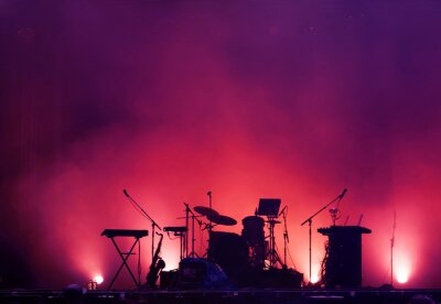 Poster concert stage on rock festival, music instruments silhouettes, colorful background with copy space
