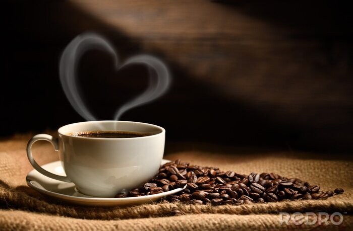 Poster Cup of coffee with heart shape smoke and coffee beans on burlap sack on old wooden background