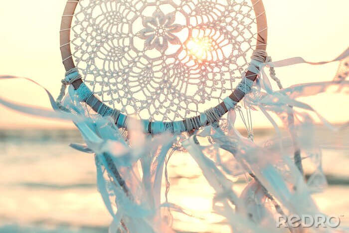 Poster Dream catcher against sunrise. Handmade work is ethnic symbol