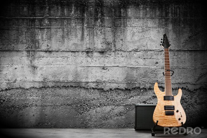 Poster Een elektrische gitaar tegen een ruwe betonnen muur