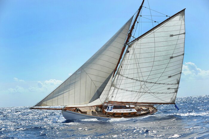 Poster Een schip met zeilen op zee