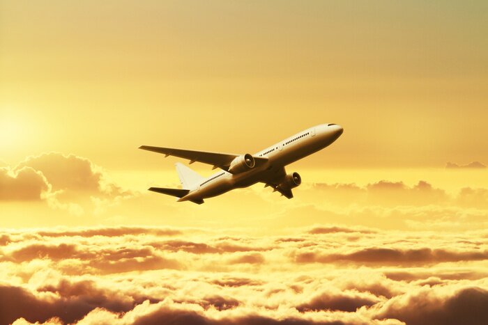 Poster Een vliegtuig in de lucht bij zonsondergang