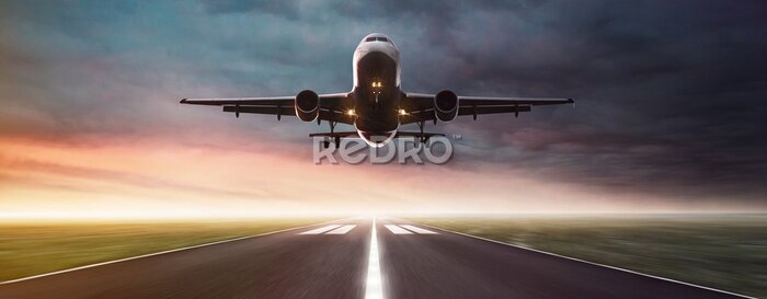 Poster Een vliegtuig landt op de landingsbaan.