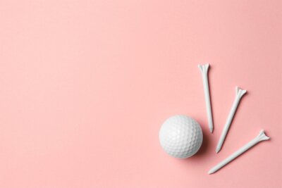 Golf ball and tees on pink background, flat lay. Space for text
