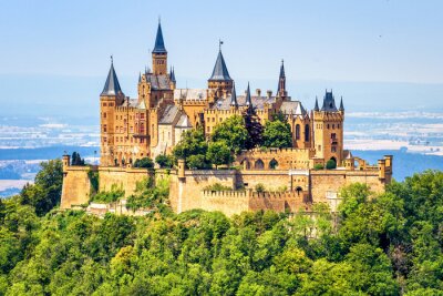 Hohenzollern Castle close-up, Germany. This fairytale castle is famous landmark near Stuttgart. Scenic view of mount Burg Hohenzollern in forest. Scenery of Swabian Alps with Gothic castle in summer.