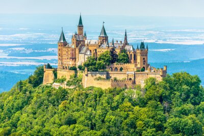 Hohenzollern Castle on mountain top, Germany. This castle is a famous landmark in vicinity of Stuttgart. Scenic view of Burg Hohenzollern in summer. Landscape of Swabian Alps with Gothic castle.