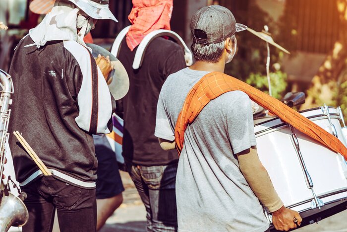 Poster Jazz music parade of Thai happiness people wearing colorful clothes in famous Songkran Water Festival on street in Kanchanaburi, Thailand.