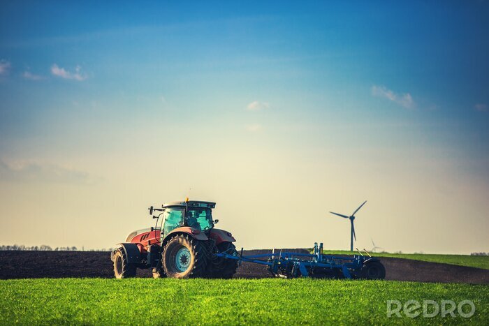 Poster Landbouwer met tractor het zaaien gewassen bij gebied