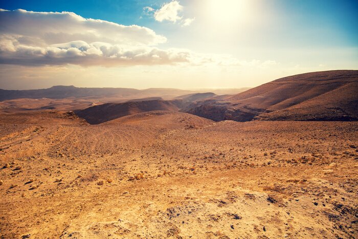 Poster Mountainous desert with a beautiful cloudy sky. Desert in Israel at sunset