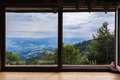 Poster Mountains, view from the window of a wooden house