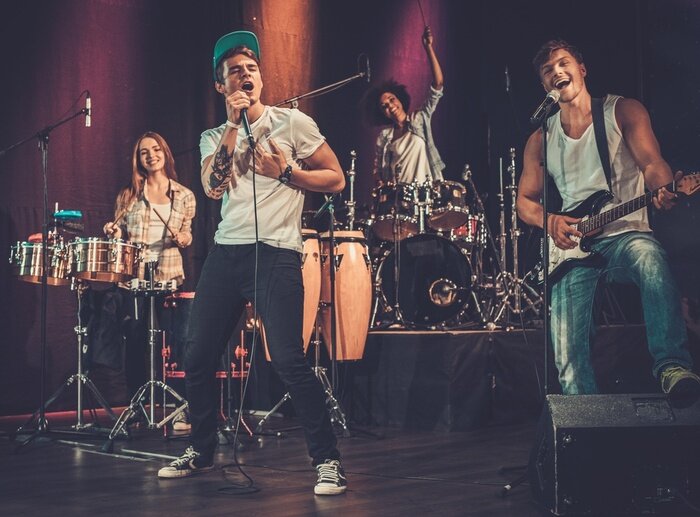 Poster Multiracial music band performing on a stage