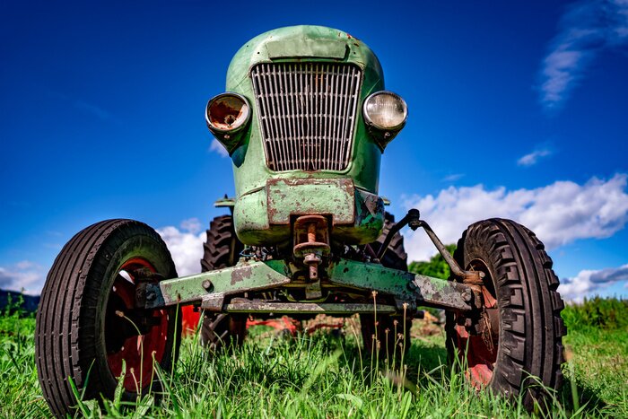 Poster Old tractor in the Alpine meadows