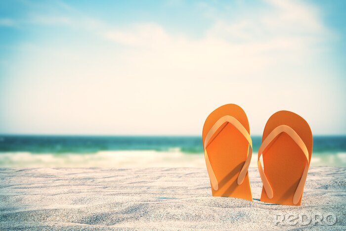 Poster Orange flip flops on beach