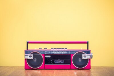 Poster Retro verouderde rode draagbare stereo radio cassette recorder van 80s voor geel achtergrond. Vintage oude instagram stijl gefiltreerde foto