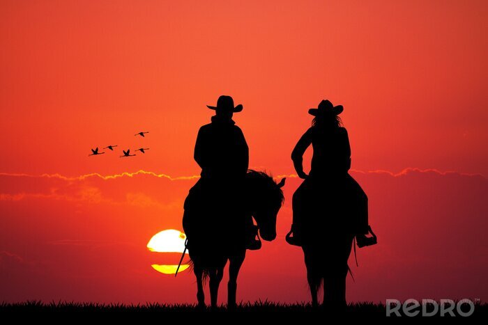 Poster Ruiters op paarden bij zonsondergang