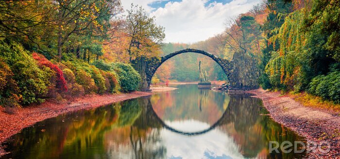 Poster Unbelievable morning scene of Azalea and Rhododendron Park Kromlau, Germany, Europe. Great autumn panorama of Rakotz Bridge (Rakotzbrucke, Devil's Bridge). Traveling concept background.