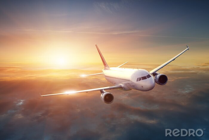Poster Vliegtuig in de hemel bij zonsondergang