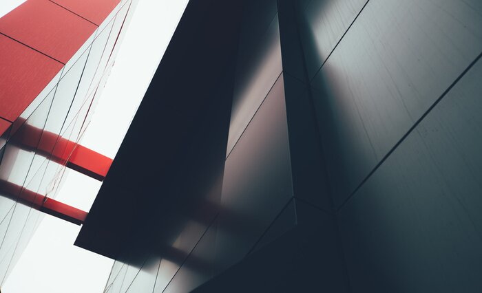 Poster Wide angle abstract background view of steel light blue high rise commercial building skyscraper made of glass exterior. concept of successful industrial architecture and office center building