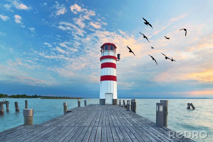 Poster Zonsondergang bij de vuurtoren op het meer