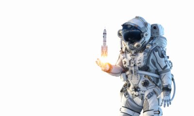 Sticker Astronaut met een raket die uit zijn hand lanceert