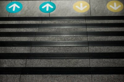 Sticker Colored Arrow Signs Sticker Placed on The Floor in front of Stairs