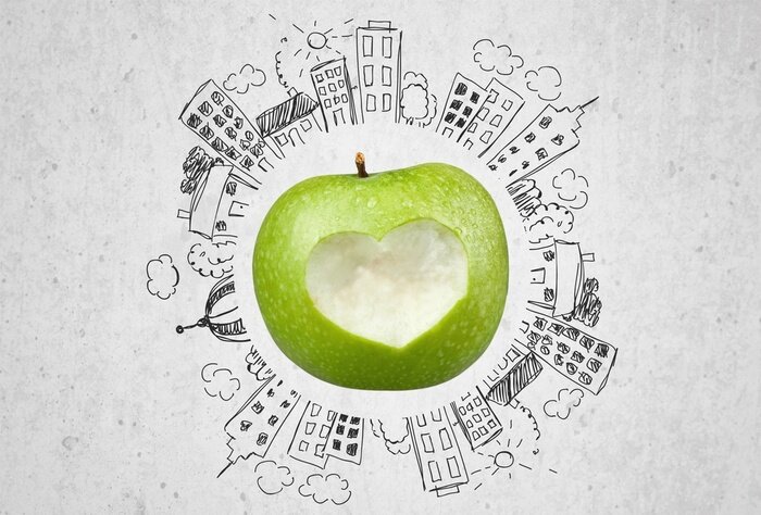 Sticker Groene appel omgeven door gebouwen