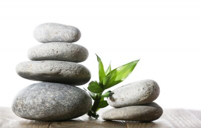 Sticker Stack of spa stones on wooden planks surface isolated on white