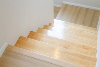 Sticker The design of staircase inside the house are paved with light brown wood laminate.